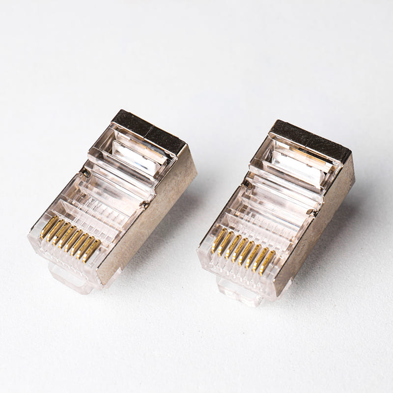 Cat5e Shielded Pass-Through RJ45 Connector - Premium 8P8C STP Modular Plug for Easy & Reliable Network Termination Image 1 Cat5e Shielded Pass-Through RJ45 Connector with wires passing through the front